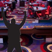 Silhouette of man celebrating in casino