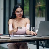 Woman with credit card on laptop