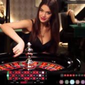 Live dealer spinning the roulette wheel