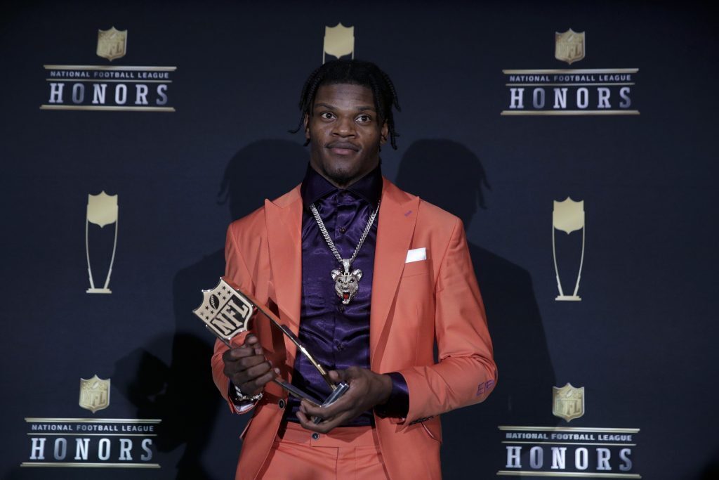 Lamar Jackson holding his MVP trophy at the NFL Honors event